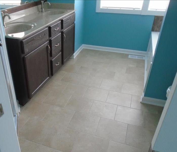 Bathroom with tile flooring and Aqua walls. 